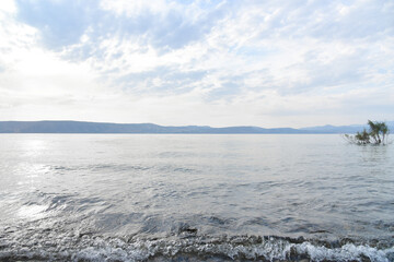 Blue cloudy sky over the Sea of Galilee and Golan Heights over the Sea of Galilee and Golan Heights. High quality photo.