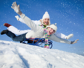 Fototapeta na wymiar couple on sledge having fun