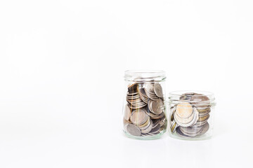 Glass bottles full of coin on white background, saving money, financial and banking concept