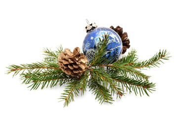 Christmas background with green needle tree twigs and decorative blue ball and cones isolated on white