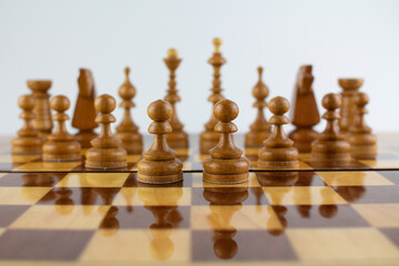 chessboard made of wooden pieces on white