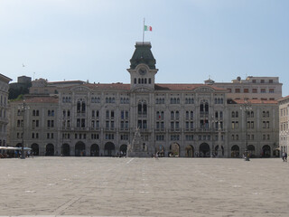 Naklejka premium Town Hall building in Piazza Unità d'Italia in Trieste, exterior with eclectic style and the fountain of the Four Continents in front