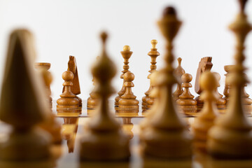 chessboard made of wooden pieces on white