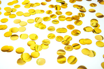 Festive, golden paper confetti in the form of circles cut on white background