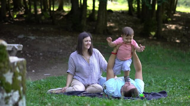 Young family with a child on a picnic in the national park
