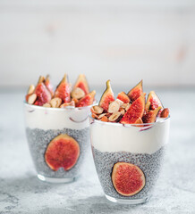 Healthy chia pudding with yogurt, figs and nuts in glass. Ideas and recipes for healthy breakfast,...