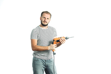 A bearded man in a striped T-shirt, holds a power tool - electric drill in his hands. Isolated on...