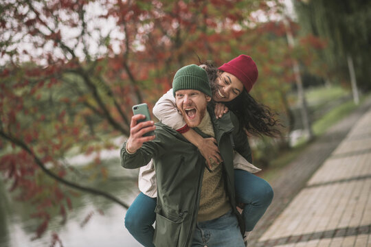 Joyful couple making crazy and emotional selfies