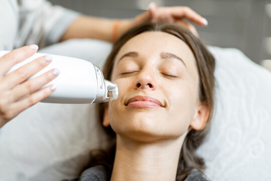 Portrait Of A Young Woman During A Facial Rejuvenation Treatment At Medical SPA. LaseMD Procedure Concept