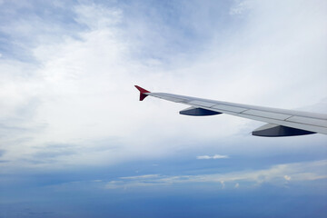 Fototapeta na wymiar A beautiful blue sky with airplane wing viewed from airplane window