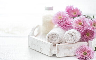 Fototapeta na wymiar Spa composition with body care products and pink flowers.