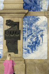 azulejos panel represent country scenes on the walls of Sao Bento train station in Porto