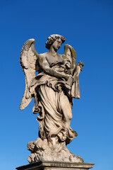 Angel with the Whips (Scourge) statue on Ponte Sant Angelo bridge in Rome, Italy. Marble sculpture from 17th century by Lazzaro Morelli