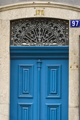detail of the cast iron decorations above the doors in the old town of Porto, Portugal