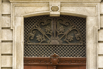 detail of the cast iron decorations above the doors in the old town of Porto, Portugal