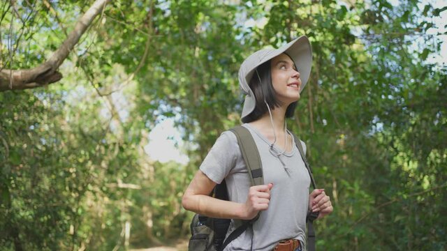 Caucasian young beautiful girl travel through a forest in the summer.