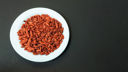 dried goji berries on a white plate