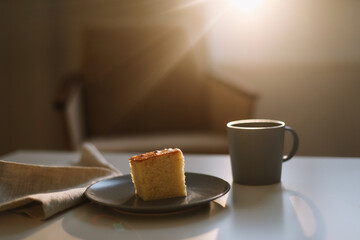 Homemade fresh cake. Table with a piece of cake and cup of coffee or tea