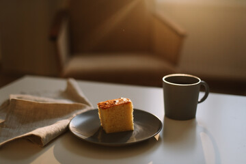 Homemade fresh cake. Table with a piece of cake and cup of coffee or tea
