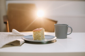 Homemade fresh cake. Table with a piece of cake and cup of coffee or tea