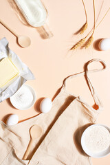 Raw ingredients for baking on the beige table, top view background