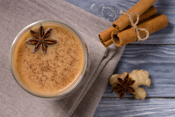 Hot masala tea with spices, cinnamon, ginger and star anise, in glass