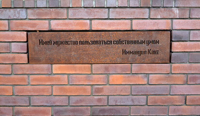 KALININGRAD, RUSSIA.  A plaque with the saying of Immanuel Kant "Have the courage to use your own mind" in a brick wall. Russian text