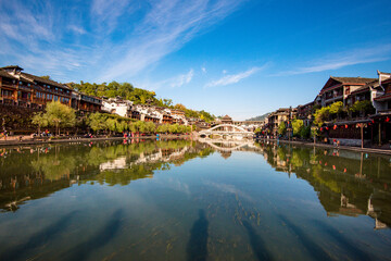 the river, the boat, stone bridge and the old houses at ancient phoenix town in the morning at Hunan, China.