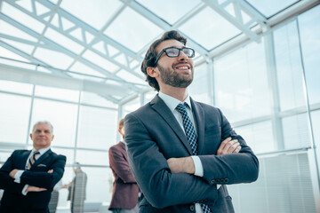 confident business man standing in a modern office