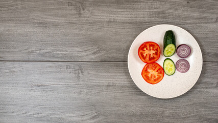 Ingredients for vegetable salad. Onion, tomato, cucumber top view