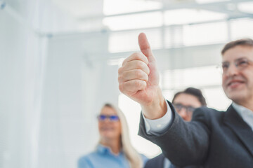 close up.happy businessman giving a thumbs up