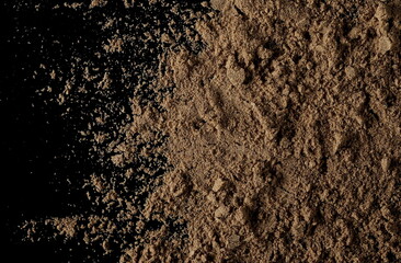 Organic linseed protein powder pile isolated on black background