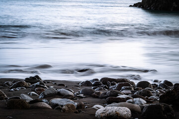 Calm waves touching beach stones on Madeira island