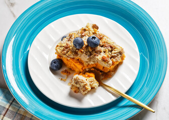 Pumpkin dump cake with blueberries on a plate