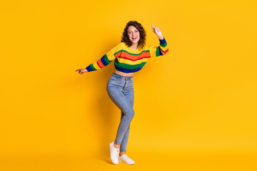 Fototapeta na wymiar Full length photo of crazy lady dance direct finger up wear striped cropped pullover denim jeans footwear isolated yellow color background