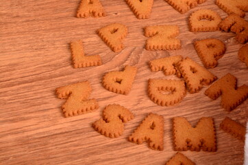 Gingerbread letters cookies on a brown wooden background