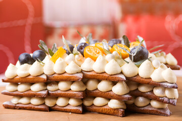 Traditional homemade layer cake with cream and fruit. Christmas holidays celebration.