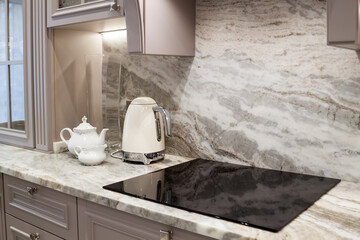 beautiful closeup of custom designed kitchen, with marble looking quartz countertop and backsplash....