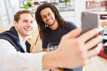 Smiling friends take selfie with smartphone or livestream