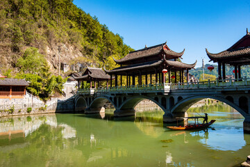 the river, the boat, stone bridge and the old houses at ancient phoenix town in the morning at Hunan, China.