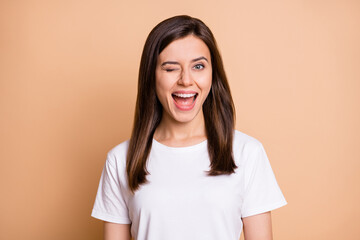 Photo portrait of funky female student winking blinking smiling in white t-shirt isolated pastel...