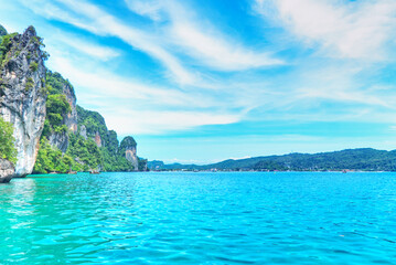 Beautiful turquoise sea with background cliff mountain and blue sky.