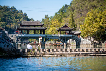 ourists walking along Phoenix Ancient Town (Fenghuang County). Awesome view of scenic old street....