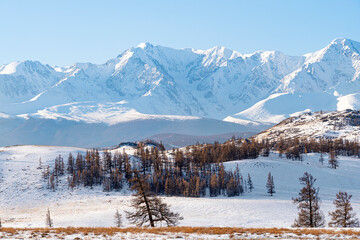 beautiful snowy landscape with mountains in background. Steppe landscape of the Altai mountains or...