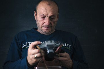 Older photographer check his film camera