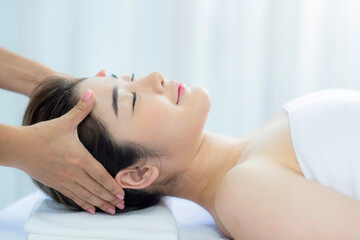 Obraz na płótnie Canvas Woman receiving head massage at a spa