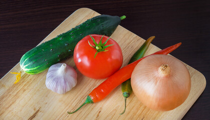 ripe fresh vegetables on a wooden background