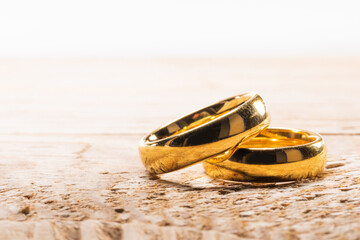 Golden wedding rings on wood