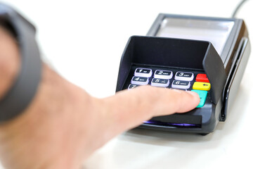 Finger clicks on a transaction confirmation at a credit card payment terminal.