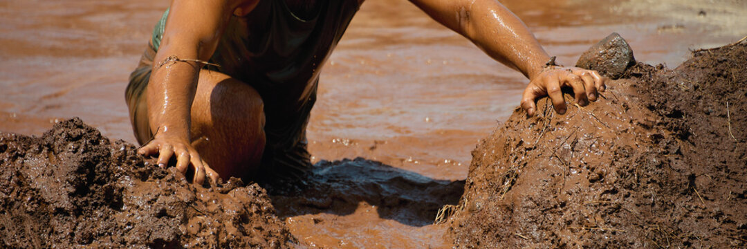 Mud race runners, obstacles during extreme obstacle race	